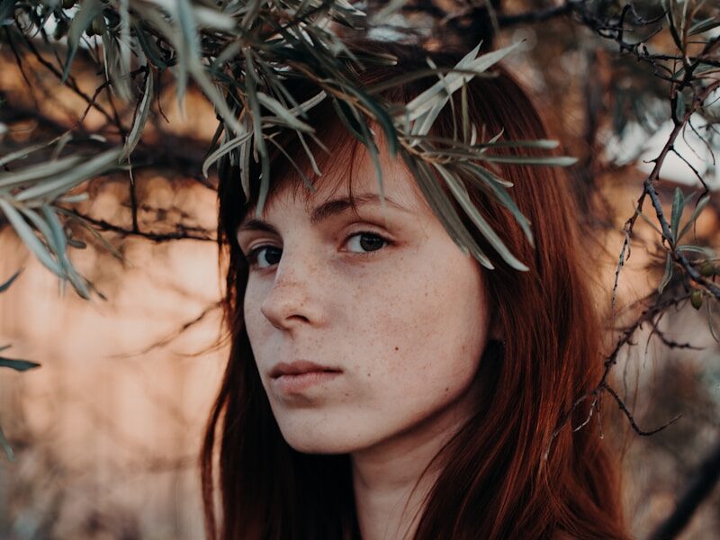 woman standing under green leafed tree