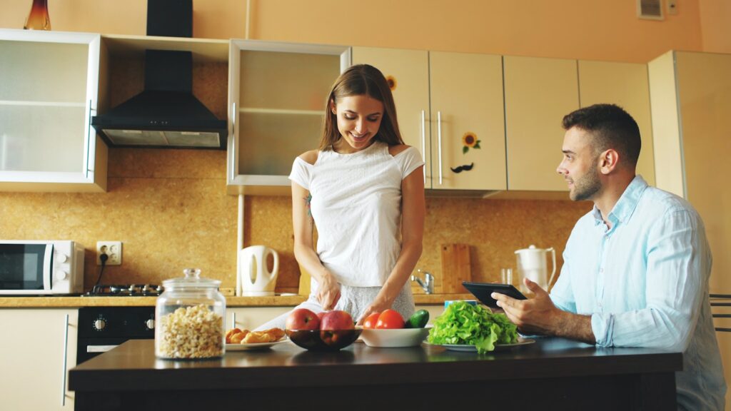 Couple preparing food together in a modern kitchen