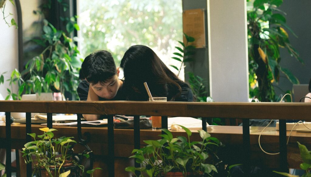 a man and woman looking at each other through a window