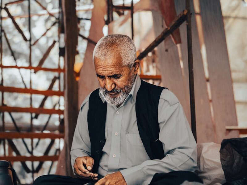 A man sitting on the ground working on something