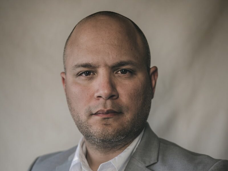 a man in a gray suit and white shirt
