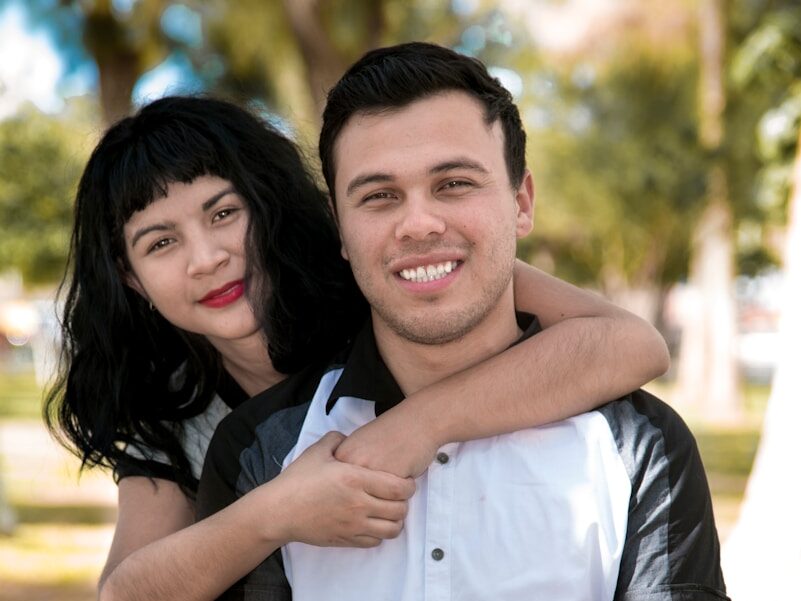 a man holding a woman in a park