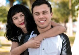 a man holding a woman in a park