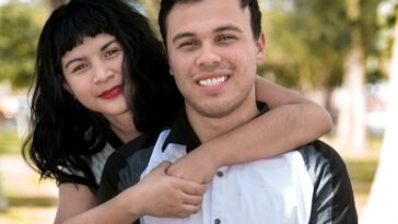 a man holding a woman in a park