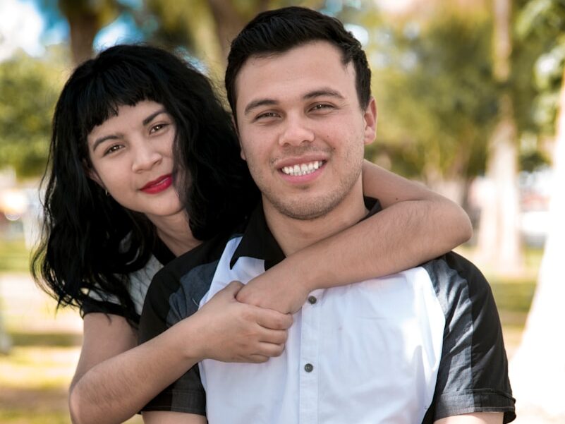 a man holding a woman in a park
