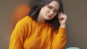 woman holding her eyeglasses