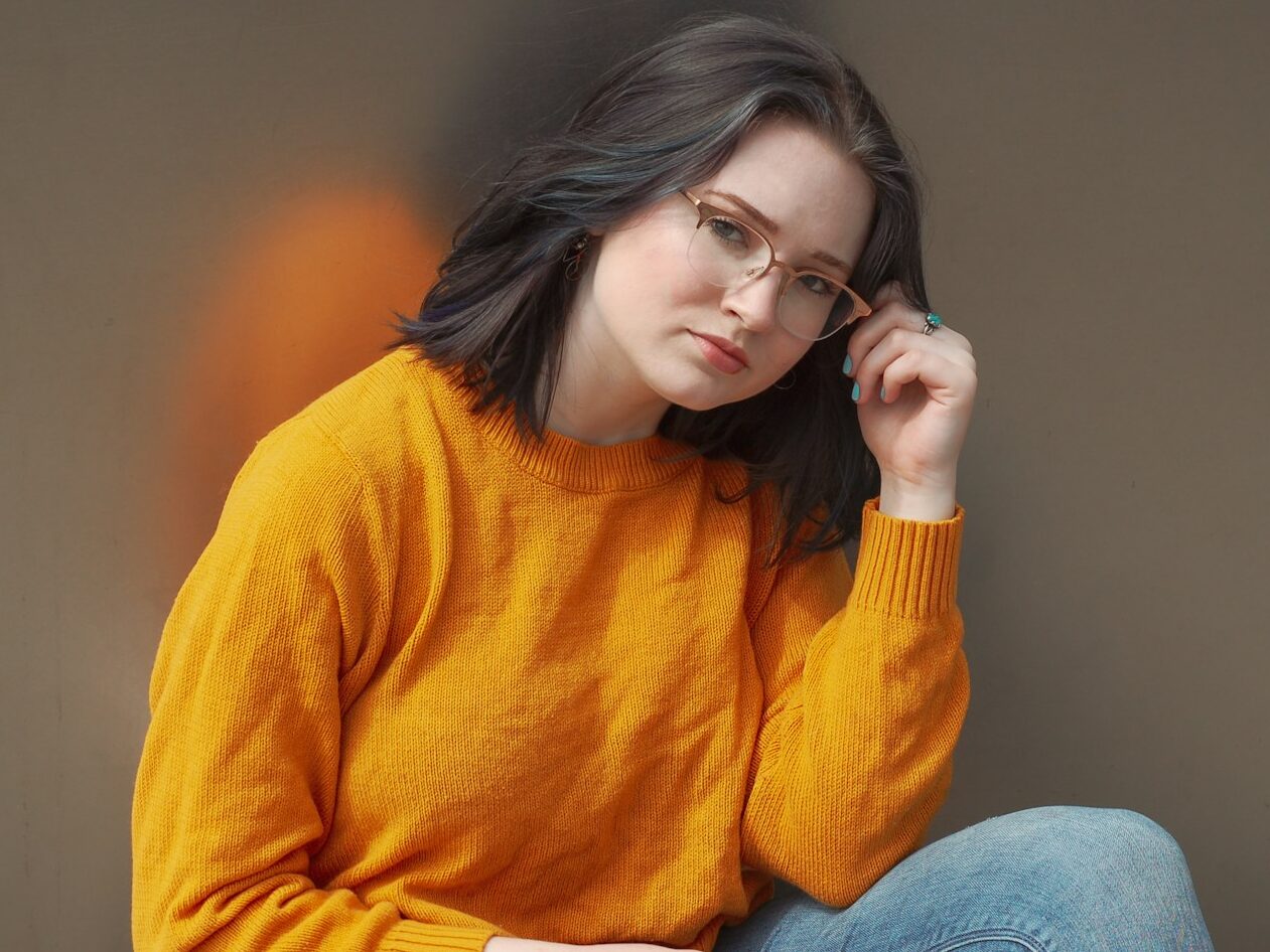 woman holding her eyeglasses