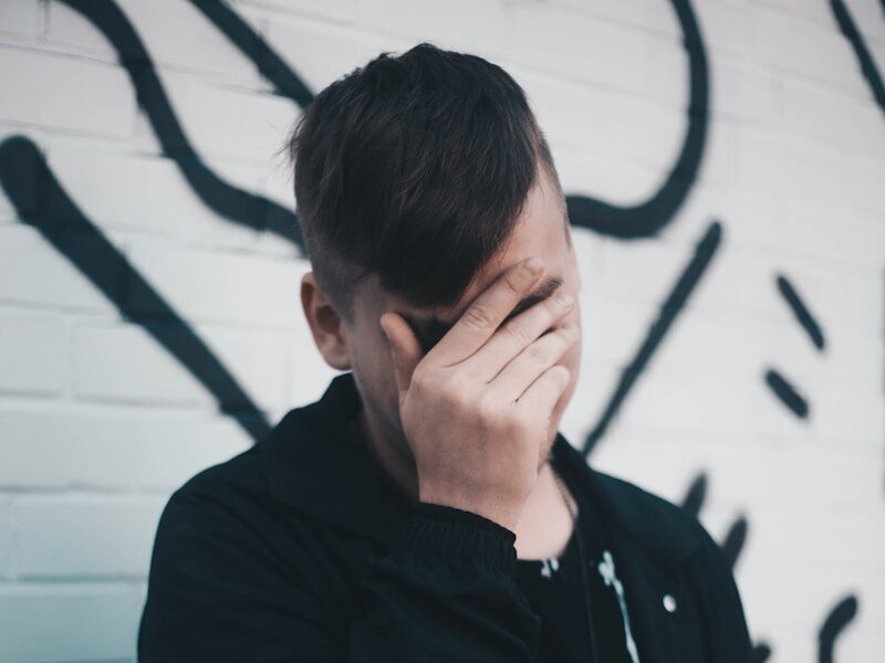 man touching his forehead
