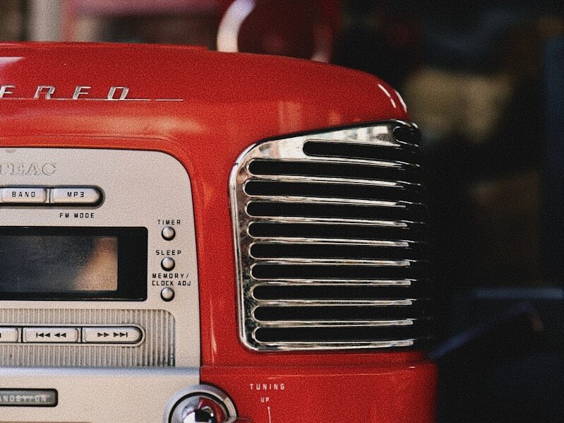 A vintage red stereo on top of a tv.