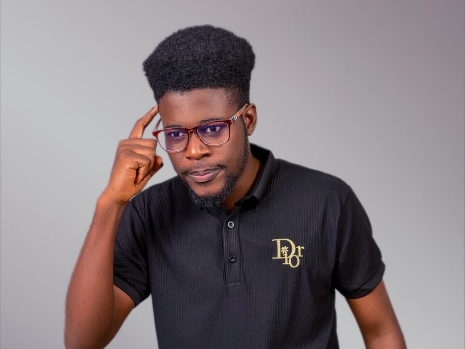 A man in a black polo shirt is talking on a cell phone