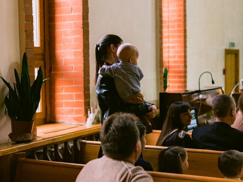 a group of people sitting in pews in a church