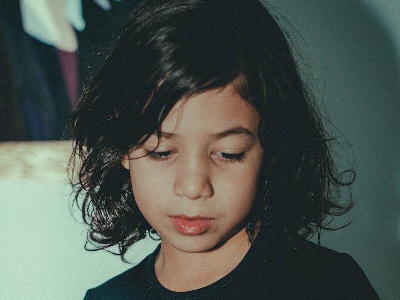 a young girl looking at her cell phone