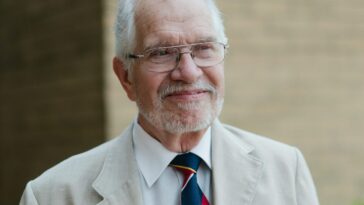 An older gentleman poses for a portrait.