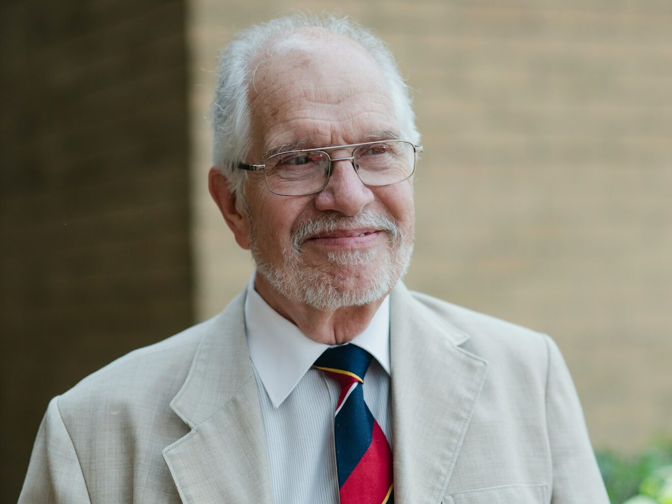 An older gentleman poses for a portrait.