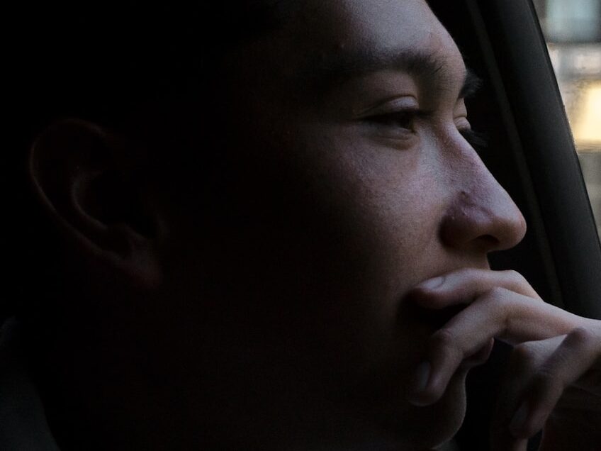 close-up photo of man looking outside vehicles window