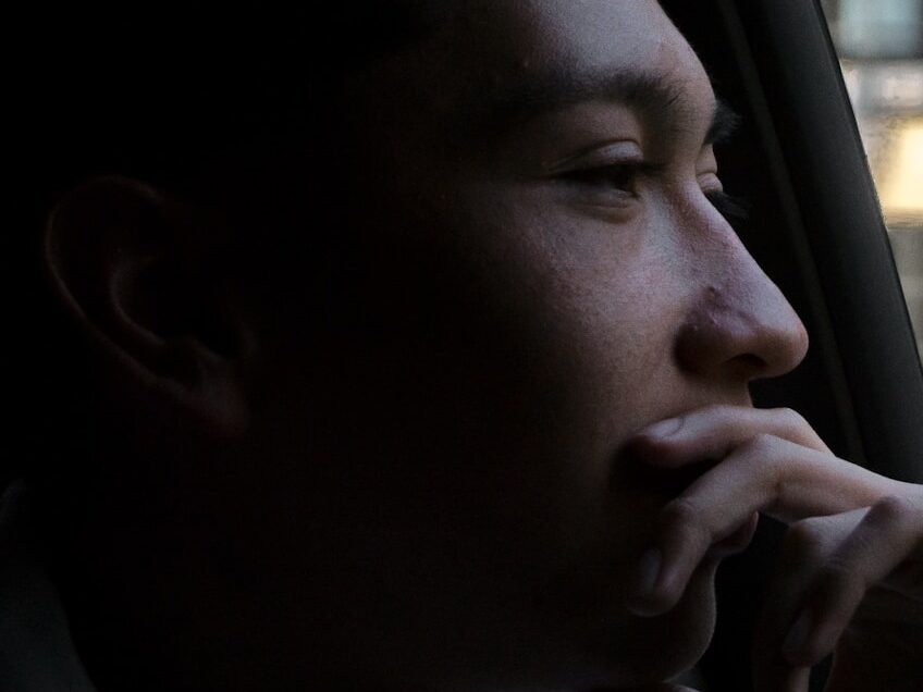 close-up photo of man looking outside vehicles window