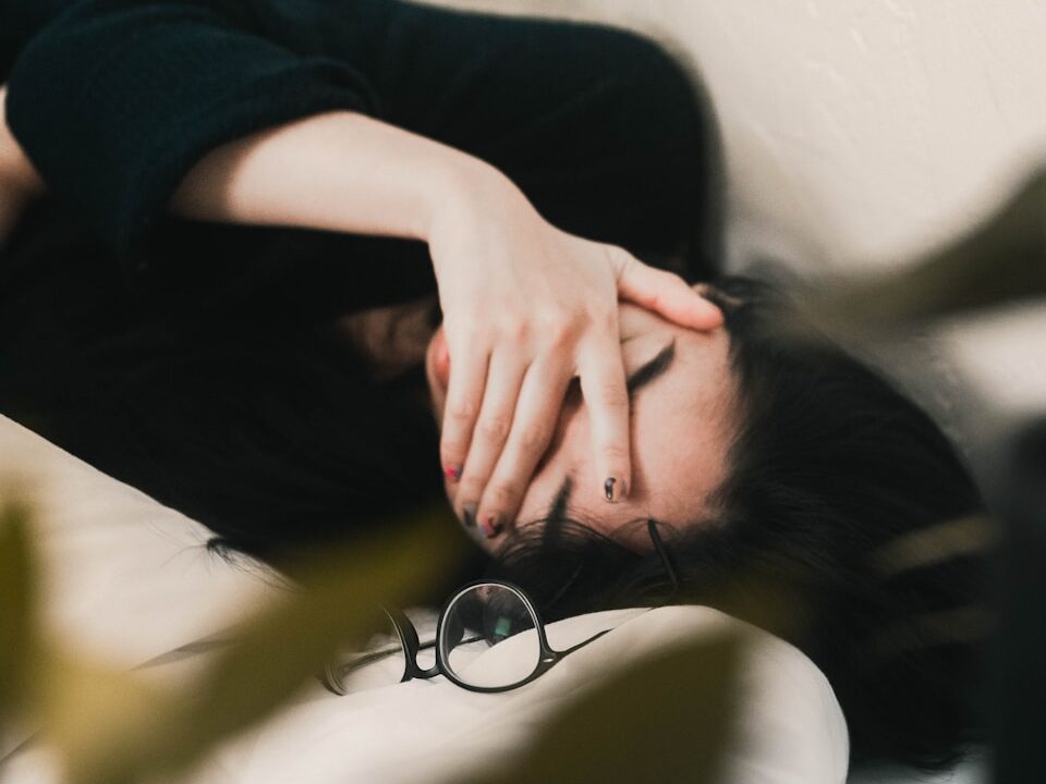 woman in black long sleeve shirt covering her face