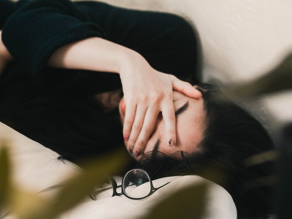 woman in black long sleeve shirt covering her face