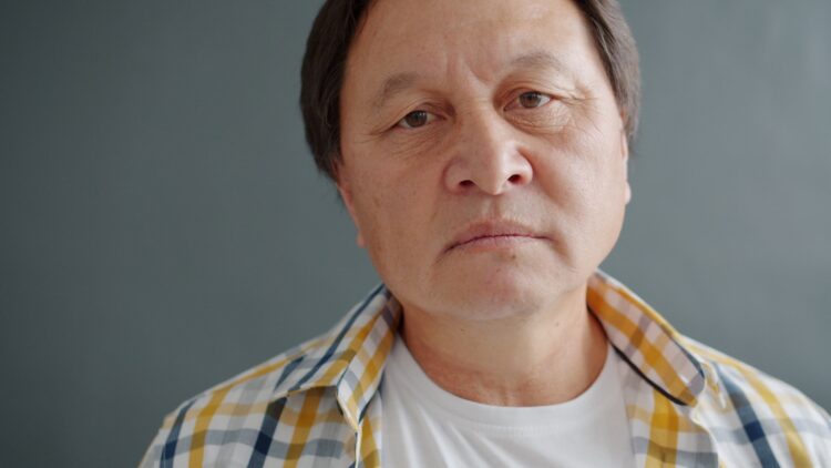Close-up of an older asian man's face.