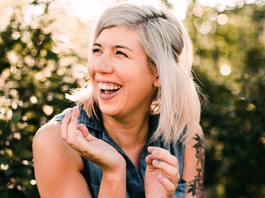woman in black tank top smiling
