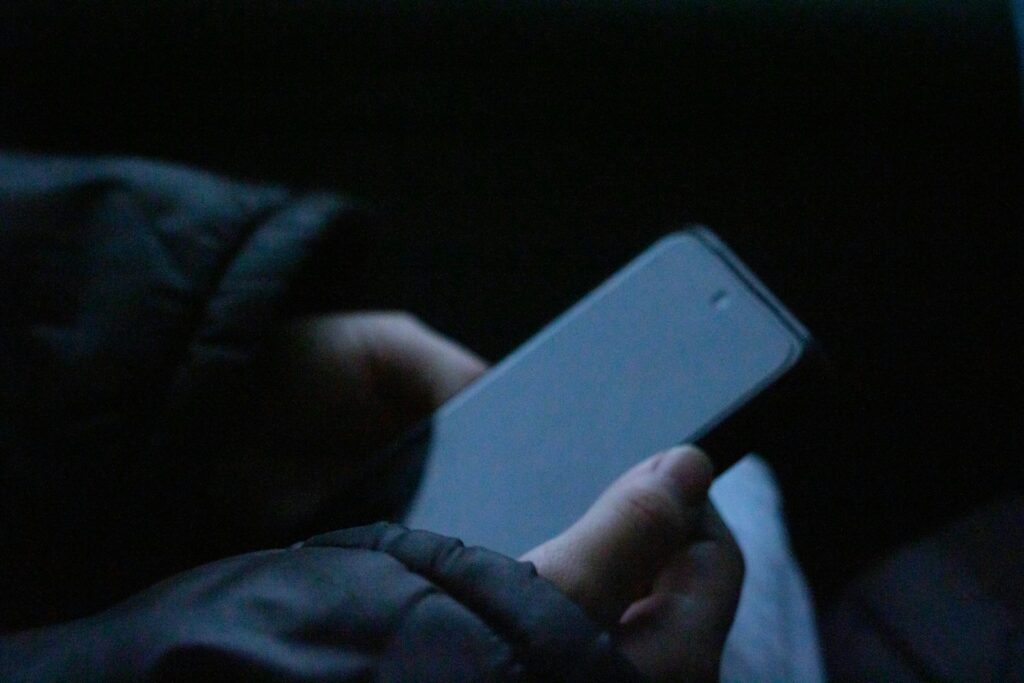 A person holding a cell phone in their hand