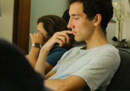 Two people sitting indoors, deep in thought and contemplation.