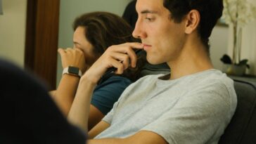 Two people sitting indoors, deep in thought and contemplation.