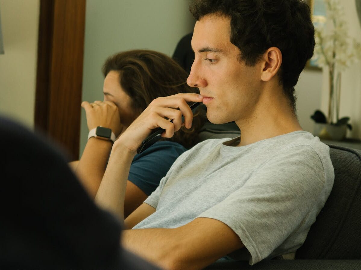 Two people sitting indoors, deep in thought and contemplation.