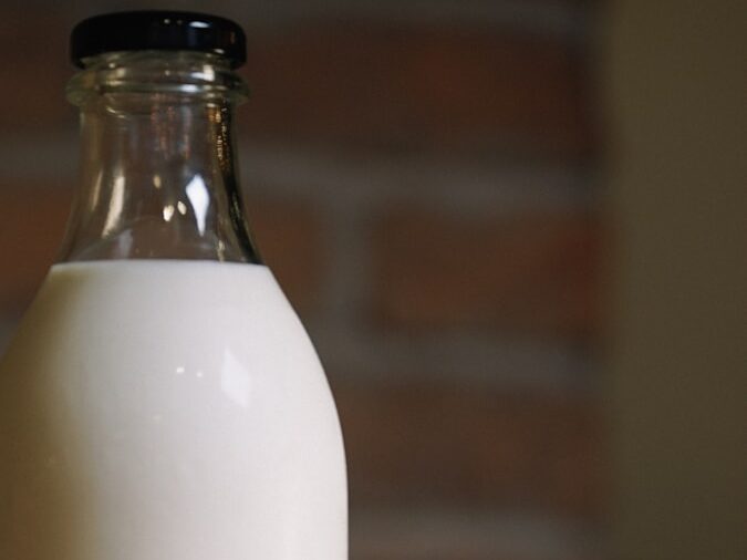 white plastic bottle on brown wooden table