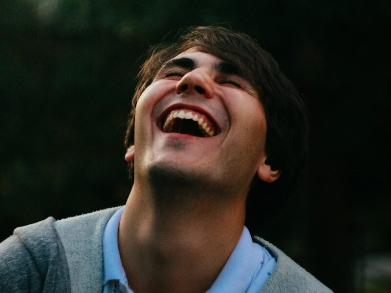 man in gray sweater smiling