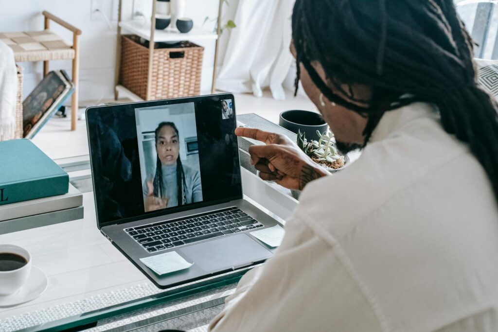 An African American couple arguing during a video call on a laptop indoors.