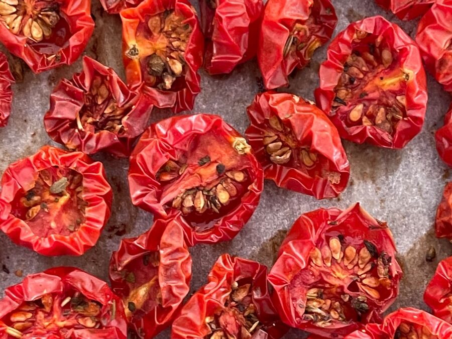 a bunch of red peppers sitting on top of a counter