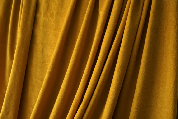a close up of a curtain with yellow fabric