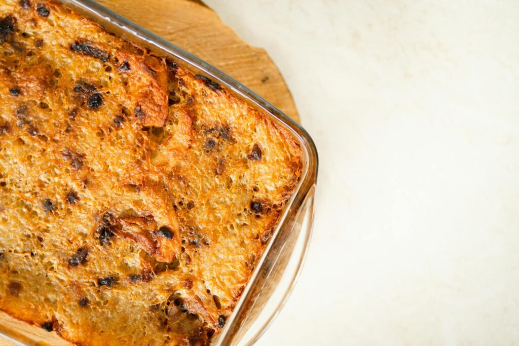 Deliciously golden bread pudding freshly baked in the oven, captured from an overhead angle.
