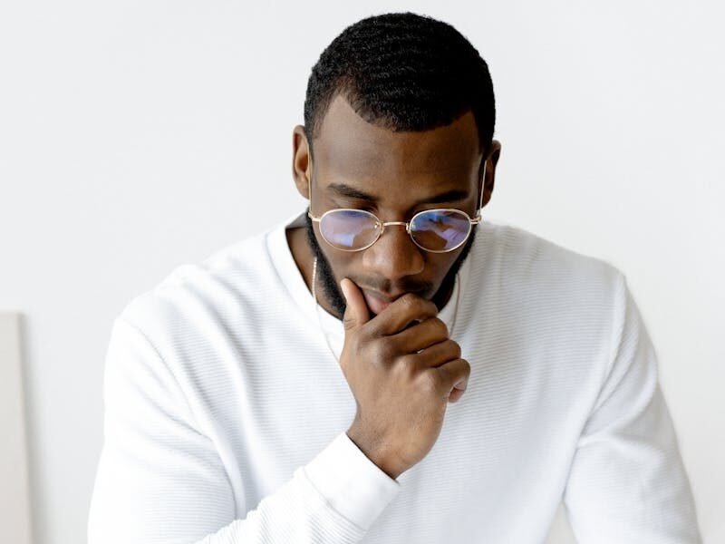 Businessman in an office setting reviews documents, indicative of focus and professionalism.
