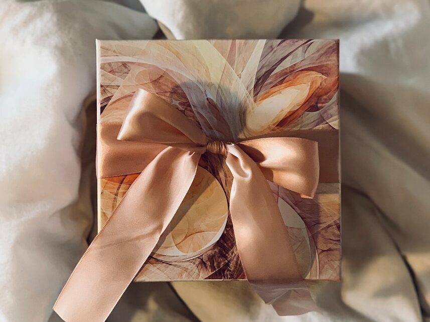 white and brown floral paper on white textile