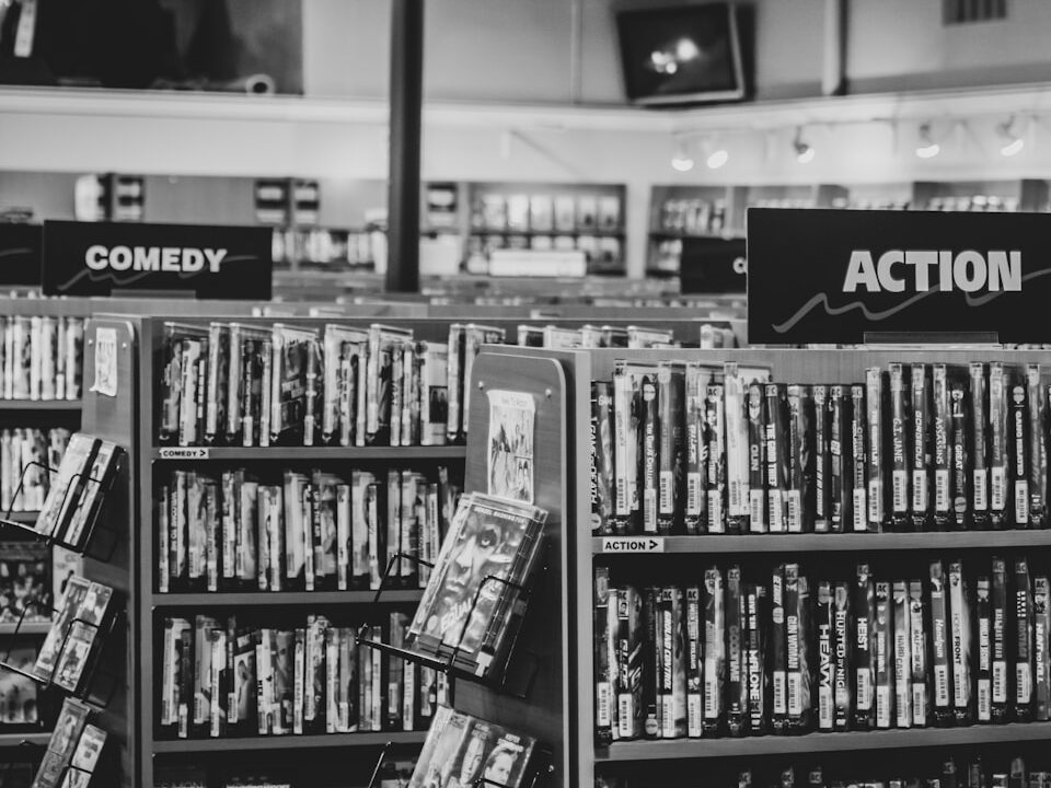 grayscale photo of books on shelves