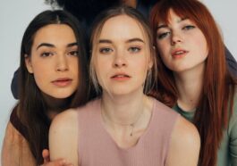 A diverse group of women posing elegantly in a studio setting.