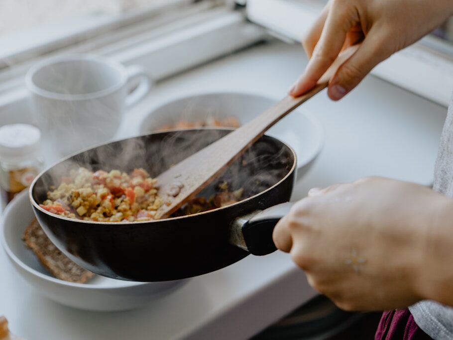 person holding black frying pan