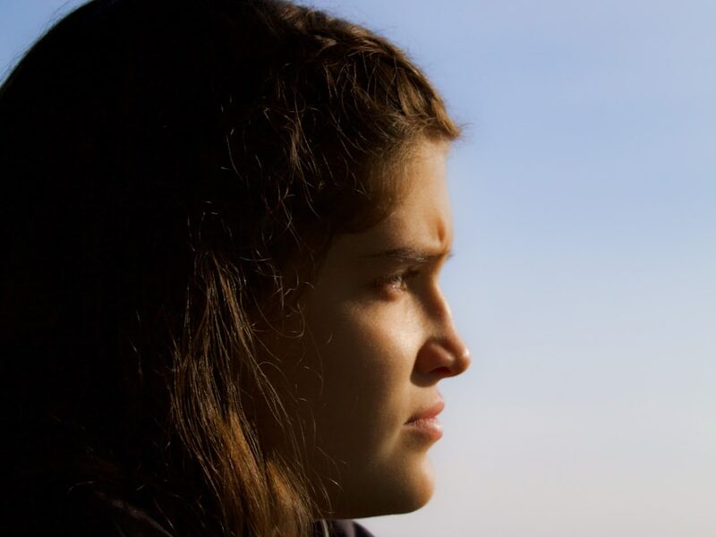 a woman looking out the window of a bus