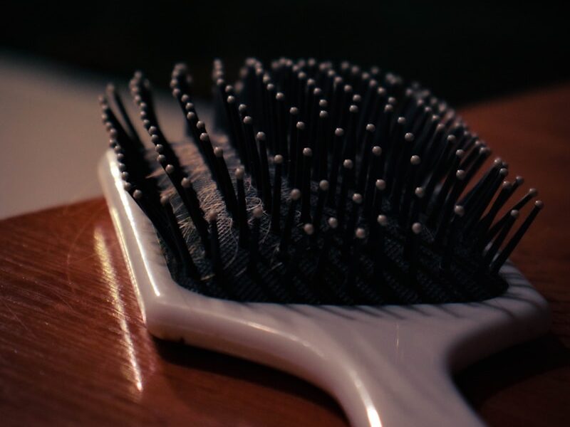 a close up of a hair brush on a table