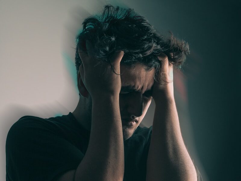 a man holding his head in his hands