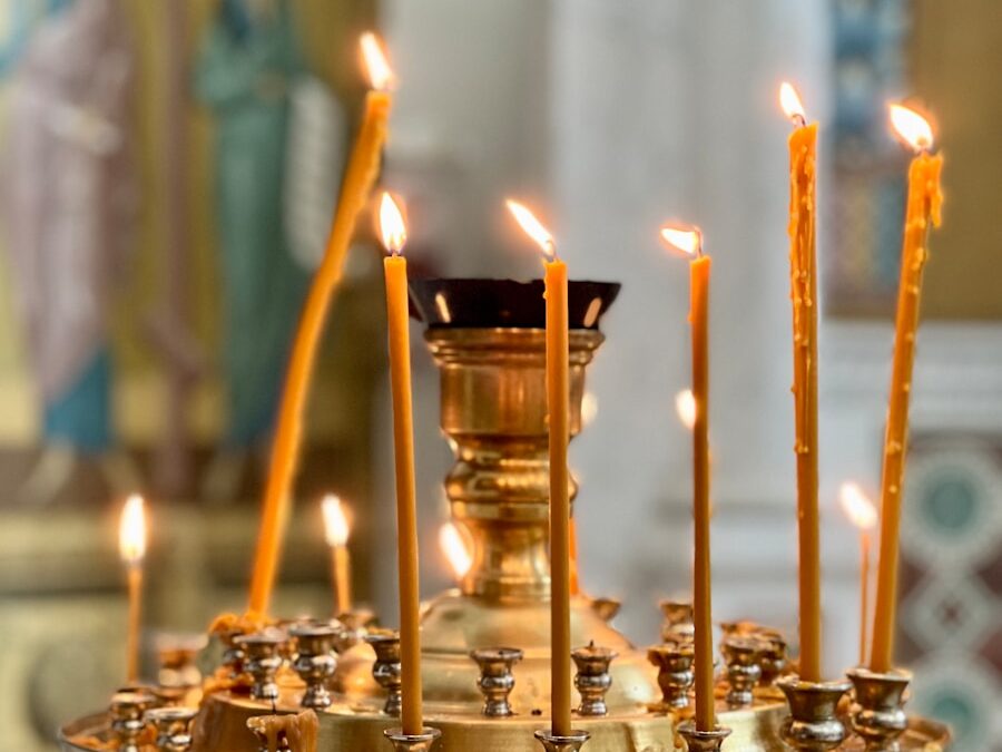 a candle holder with many lit candles in it