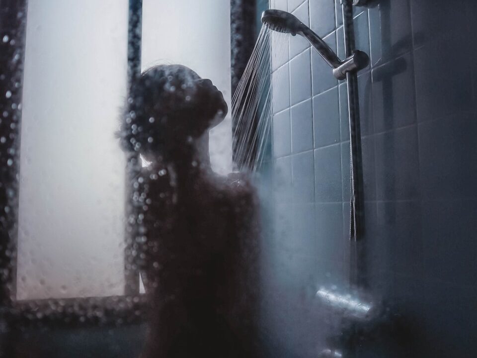 woman under showerhead