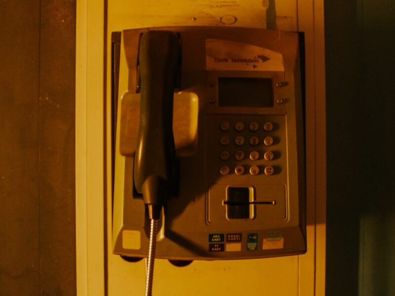 an old fashioned telephone with a cord attached to it