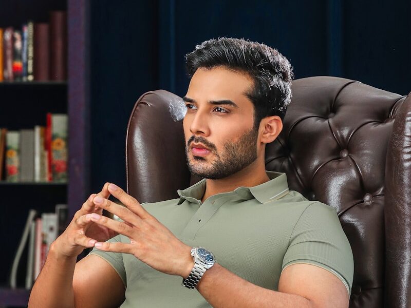 A man is deep in thought while sitting.