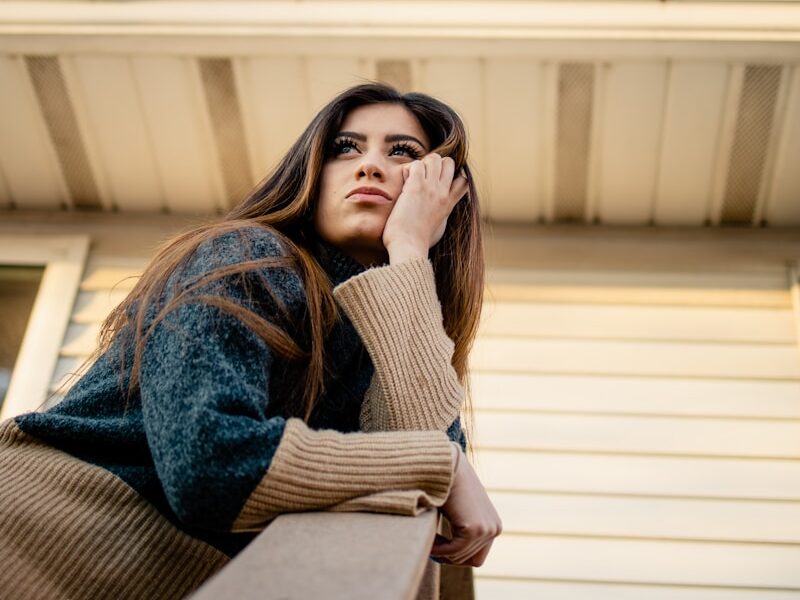 woman in blue denim jacket and brown scarf