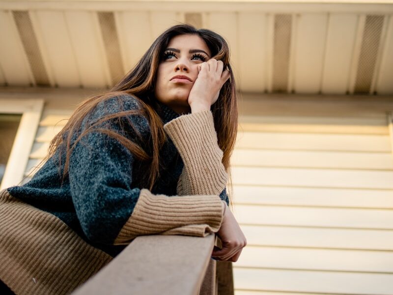 woman in blue denim jacket and brown scarf