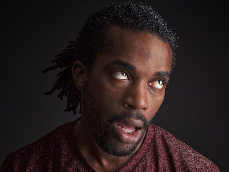 man opening his mouth and looking up
