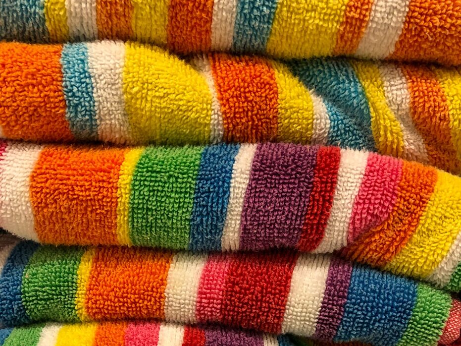 a stack of multicolored towels sitting on top of each other
